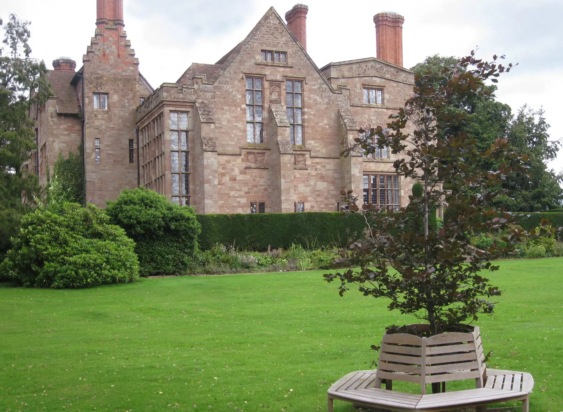 Side view of Adcote Hall with landscaped gardens